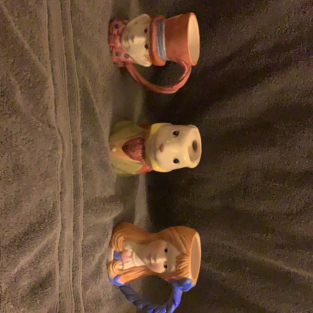 Three Alice and Wonderland themed mugs.